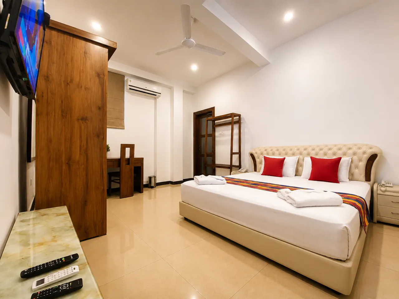 Clean air-conditioned guest room at Hotel Rosenro with bed, television, and seating.